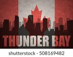 abstract silhouette of the city with text Thunder Bay at the vintage canadian flag background