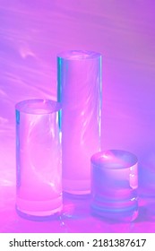 Abstract Surreal 3d Scene - Empty Stage With Three Clear Glass Cylinder Podiums On Pastel Neon Pink Holographic Background In Water. Pedestal For Cosmetic Product Packaging Mockups Display