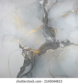 Abstract textured art with gold and silver — grey background with beautiful smudges made with alcohol ink, silver acrylic and golden paint. Fluid texture resembles marble and aquarelle.