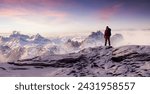 Adventurous Man Hiker on peak. Snowy mountain view. Adventure Composite. 3d Rendering. Aerial Image of landscape from BC, Canada. Sunset