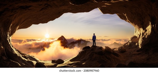 Adventurous Man Hiker standing in a cave with rocky mountains in background. Adventure Composite. 3d Rendering Peak. Aerial Image of landscape from British Columbia, Canada. Sunset Cloudy Sky - Powered by Shutterstock