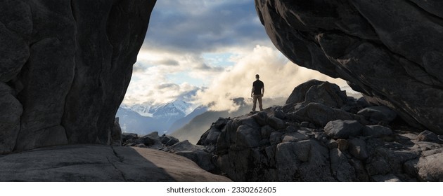 Adventurous Man Standing in cave on top of Mountain. Extreme Adventure Composite. 3d Rendering Peak. Background Aerial Image from British Columbia, Canada. - Powered by Shutterstock