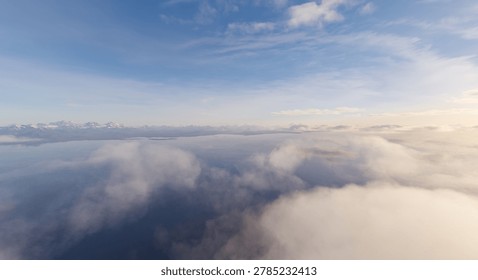 Aerial 3d Rendering of soft clouds drifting over calm water with distant snowy mountains under a pale morning sky.