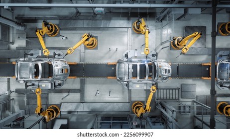 Aerial Car Factory 3D Render: Automated Robot Arm Assembly Line Manufacturing Advanced High-Tech Green Energy Electric Vehicles. Construction, Building, Welding Industrial Production Conveyor