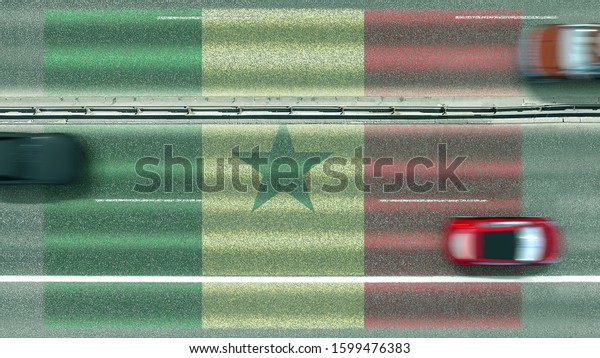 Aerial top down view of\
cars and flag of Senegal on the road. Traveling related conceptual\
3D rendering