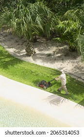 Aerial View Of A Gardener With A Lawn Mower, In A Public Garden In Playa Del Carmen, Mexico