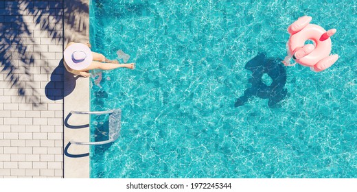 Aerial View Of A Woman With Hat Sitting On The Edge Of The Pool With Palm Tree Shadow And Flamingo Float Floating In The Water. Summer Background. 3d Render