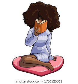 Afro hairstyle woman sitting on the floor wearing a dress while holding a book, reading