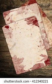 Aged Bloody Papers On Wood