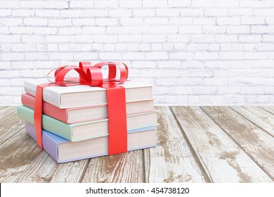 Aged wooden surface with stack of colorful books tied up with a ribbon as a present on white brick wall  background. 3D Rendering