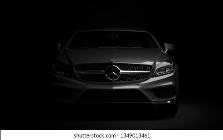 Almaty, Kazakhstan - march 24, 2019: Mercedes-Benz cls 500 AMG stylish luxury business class fast car on dark background. Mercedes-Benz logo and bumper. 3d render