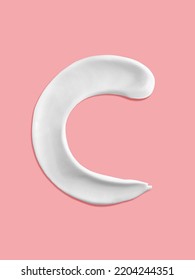 Alphabet Letter C Handwritten, White Cream Moisturiser Texture Smear Stroke Isolated On Pink Background
