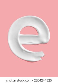 Alphabet Letter E Handwritten, White Cream Moisturiser Texture Smear Stroke Isolated On Pink Background
