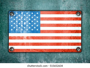 American flag on metal plate screwed screws on wall. Old grunge background