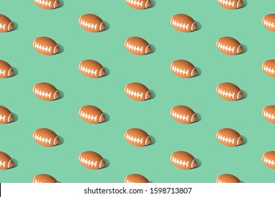 American football ball pattern on green background minimal creative sport concept.