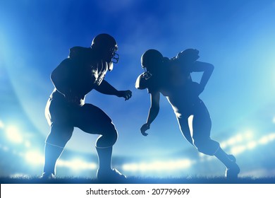 American Football Players In Game, Quarterback Running. Night Stadium Lights