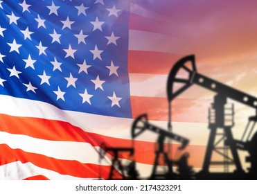 American Oil Fields. Oil Pump In Front Of American Flag. Oil Production In USA. Petroleum Derricks Before Sunset. Extraction Of Hydrocarbons In American States. Petroleum Industry USA. 3d Image.