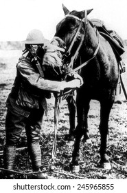 American soldier demonstrates gas masks for man and horse during WWI. Ca. 1917-18.