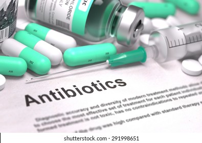 Antibiotics. Medical Report with Composition of Medicaments - LIght Green Pills, Injections and Syringe. Blurred Background with Selective Focus.