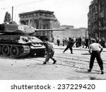 Anti-Communist riots in East Germany: An East Berliner throws stones at a Russian tank during the first violent resistance.