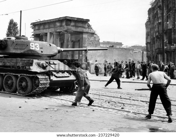 Anti-Communist\
riots in East Germany: An East Berliner throws stones at a Russian\
tank during the first violent\
resistance.