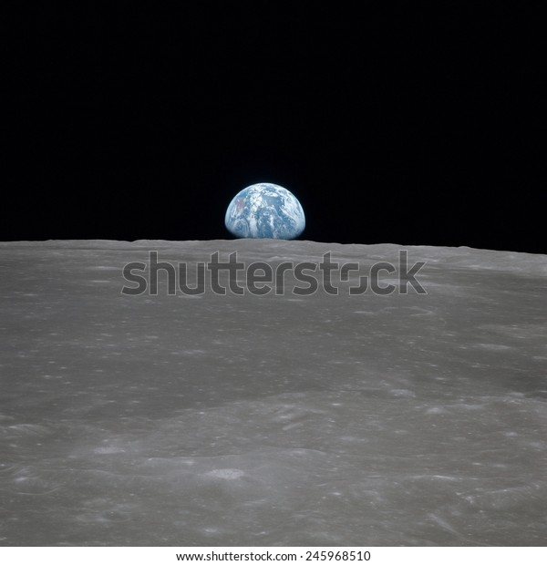 Apollo 11 Earth rise over the Moon. Earth on\
the horizon in the Mare Smythii Region of the Moon. Image 3 of a\
NASA sequence of 18. July 20,\
1969.