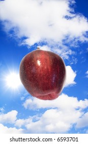 Apple flying between clouds
