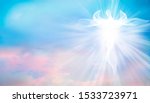 Archangel. Heavenly angelic spirit with wings. Illustration abstract white angel. Belief. Afterlife. Spiritual Angel. Blessing. Sky clouds with bright light rays. Heaven. Faith. Web banner