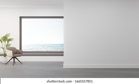 Armchair on concrete floor of large living room in modern house or luxury hotel. Minimal home interior 3d rendering with beach and sea view.