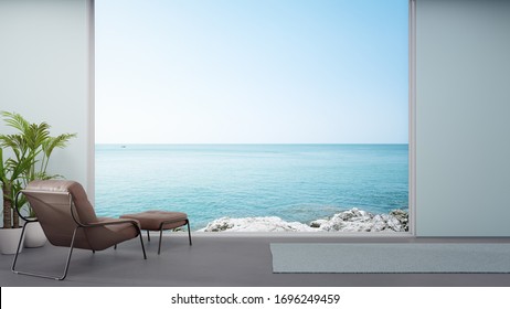 Armchair On Concrete Floor Of Large Living Room In Modern House Or Luxury Hotel. Minimal Home Interior 3d Rendering With Sky And Sea View.