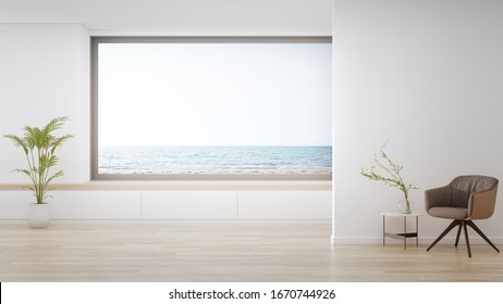 Armchair On Wooden Floor Of Large Living Room In Modern House Or Luxury Hotel. Minimal Home Interior 3d Rendering With Beach And Sea View.