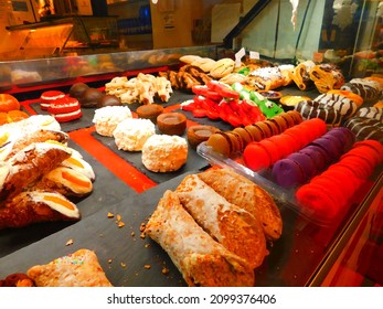 An Array Of Italian Desserts Laid Out In A Shop Window.