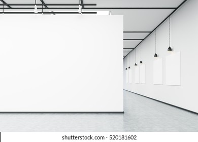 Art Gallery With Large White Wall And Several Empty Banners Hanging On White Wall. Concrete Floor. Concept Of An Art Exhibition. 3d Rendering. Mock Up.