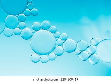 An Art Image Effect Of A Oil And Water Bubbles Circular Bubble Encircled By Created By Adding Oil Droplets To The Surface Of Water With The Addition Of Liquid Soap And Pale Blue Gradient Background.