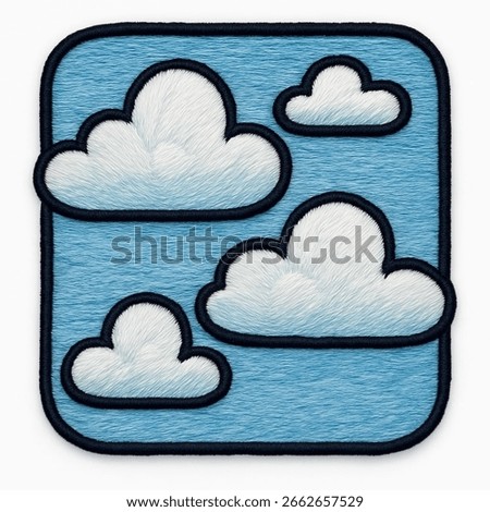 An artistic embroidered patch featuring three fluffy clouds on a light blue sky background, all with a distinct textured thread. The white clouds have a furry appearance, and the design is framed by a