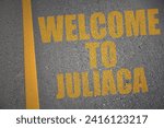 asphalt road with text welcome to Juliaca near yellow line. concept