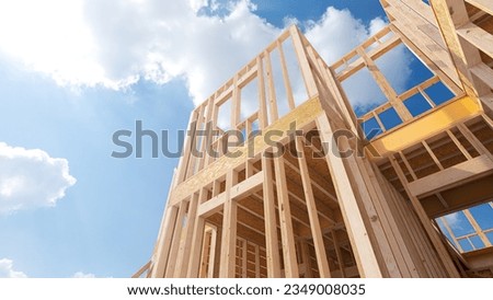 Assembling a frame house on the construction site. 3d illustration