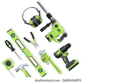 Assorted construction tools including drill, hammer, tape, wrench, and earmuffs isolated on white background with clipping path, concept of DIY