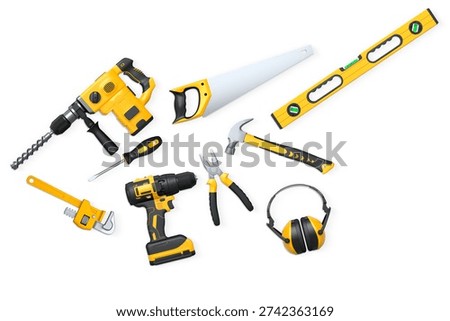 Assorted construction tools including drill, saw, pliers, and headphones isolated on white background with clipping path, concept of DIY