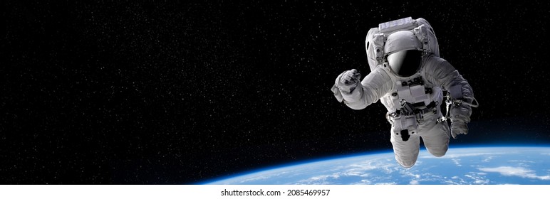 Astronaut in outer open space over the planet Earth.Stars provide the background.erforming a space above planet Earth.Sunrise,sunset.Our home. ISS.Elements of this Image Furnished by NASA