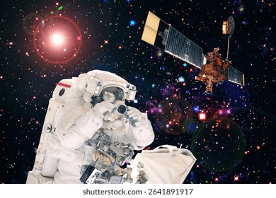 Astronaut and a satellite. The elements of this image furnished by NASA.