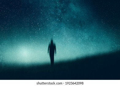 An Atmospheric, Moody Concept Of A Figure Walking Towards The Camera Silhouetted Against The Night Sky. With An Abstract, Artistic Edit.