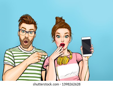 Attractive amazed young man pointing finger on mobile phone in hand wow girl in comic style. Pop art woman holding smartphone. Digital advertisement couple showing the message or new app on cellphone