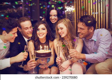 Attractive friends celebrating a birthday against flying colours - Powered by Shutterstock