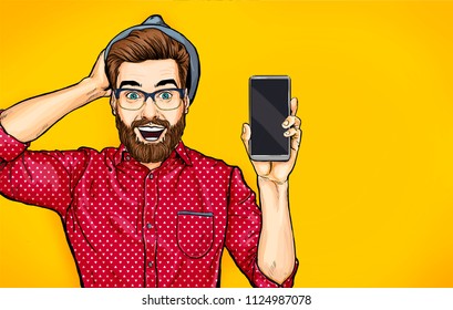 Attractive smiling hipster in specs with phone in the hand in comic style. Pop art man in hat holding smartphone. Digital advertisement male model showing the message or new app on cellphone. 