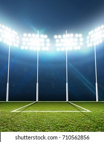 An Aussie Rules Football Stadium With A Marked Green Grass Pitch And Goal Posts In The Nighttime Under Illuminated Floodlights - 3D Render