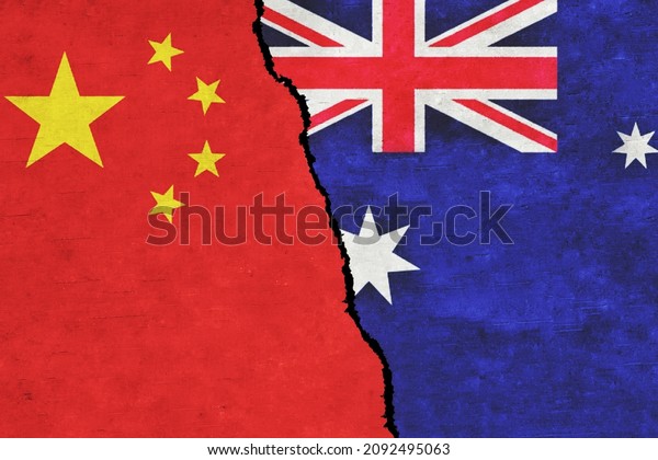 Australia and China painted flags on a wall with a\
crack. Australia and China relations. China and Australia flags\
together. Australia vs\
China