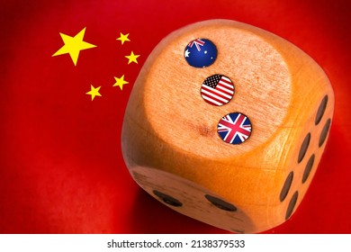 Australia, Uk And Usa AUKUS Alliance Countries Flags Paint Over On Wooden Dice. Chinese Flag Paint On Background.