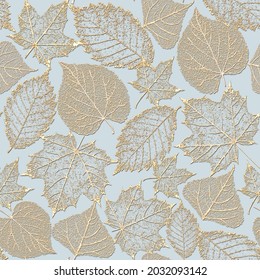 Autumn fairy abstract glitter transparent gold leaf skeleton seamless pattern. Luxury yellow golden leaves glittering ornament on pastel blue background. Print for textile, wallpaper, wrapping.