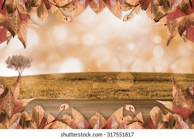Autumn leaves pattern against bleached wooden planks background